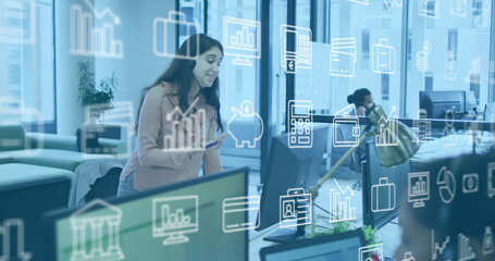 Business data and analytics image over woman enjoying music in office