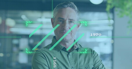 Green digital interface image over man standing in modern office