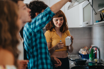 A happy group of friends enjoying time together while cooking a meal in a modern kitchen setting. The scene captures friendship, joy, and shared experiences.