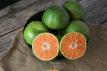 Fresh orange fruits on dark background. Citrus juicer. Summer tropical fruits. Food concept....