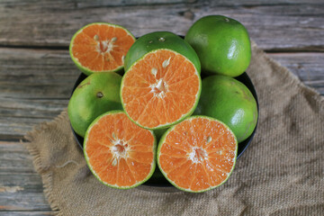 Fresh orange fruits on dark background. Citrus juicer. Summer tropical fruits. Food concept....