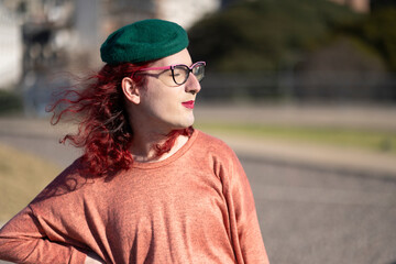 Transgender woman posing sensually in a park