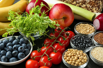 Different fresh products on black table. Source of prebiotics