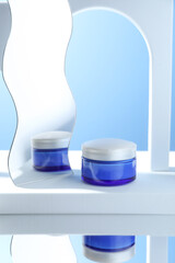 Stylish presentation of face cream in jar against light blue background