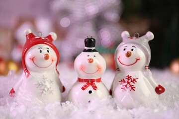 Funny snowmen figures on artificial snow, closeup