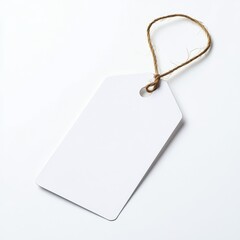 Fototapeta premium A blank white tag with a string, perfect for labeling, organizing items, or creating custom gift tags.