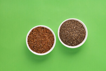 Organic chia and flax seeds in two bowls - Linum usitatissimum and Salvia hispanica.