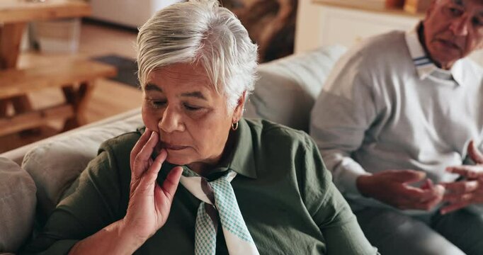 House, fight and old couple on couch, stress and conversation with marriage, crisis and frustrated. Apartment, elderly man and mature woman with emotions, relationship and conflict with argument