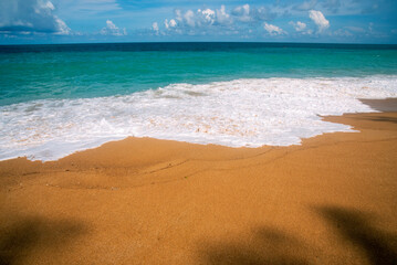 Summer tropical beach white sand blue sea summertime on sunny day. Sea coast beach scenery foamy wave on the beach waves of blue sea tropical ocean sand. Travel holidays vacation seaside turquoise