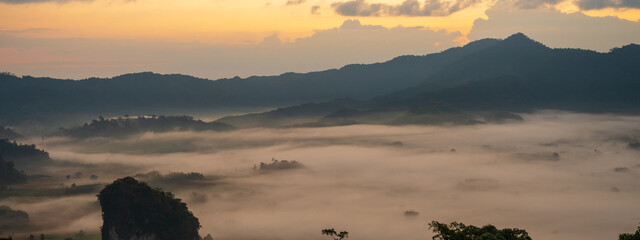 Banner Beautiful Mountain landscape foggy mountain green landscape morning sunrise. Amazing Landscape mountain green tropical forest tree on sunrise. Banner forest sunlight scenery with copy space