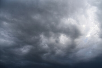 Dramatic dark storm rain clouds black sky background. Dark thunderstorm clouds rainny atmosphere. Meteorology danger windstorm disasters climate. Dark cloudscape storm disaster gloomy gray cloud sky