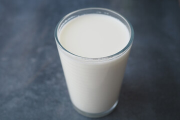 A Fresh Glass of Milk Presented on a Dark Background, Highlighting its Creamy Texture and Taste