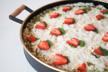 A Delicious Dish Featuring Rice, Juicy Strawberries, and a Fresh Mint Garnish Delightfully Appealing