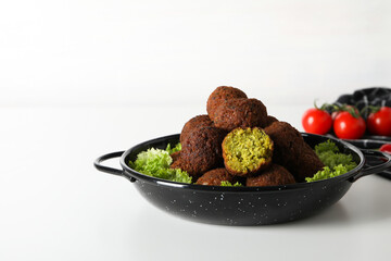 Falafel in a plate, on a light background.