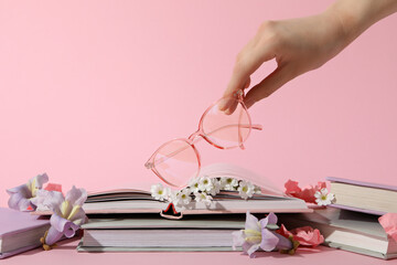 Books with wrapped pages on a pink background.
