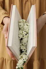Aesthetics of books with flowers on a light background.