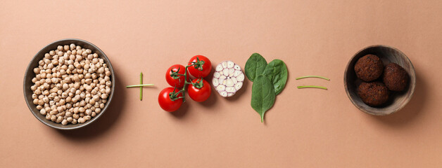 Ready falafel with ingredients on a brown background.
