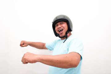 asia man wearing helmets pretend to ride motorbikes while looking ahead, safety on motorbikes