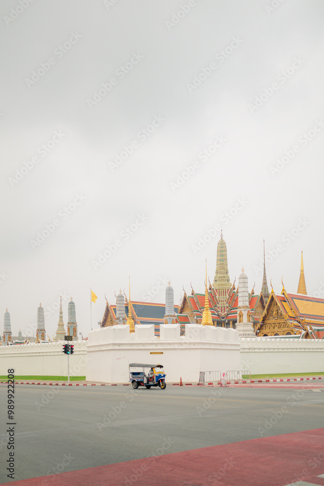 Wall mural asia local travel in city activity with local taxi (tuk tuk) parking for wait tourism on street of bangkok Thailand with grand palace landmark background