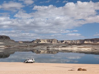 Nomadic overlanding vehicle on beach at Lake Powell recreation area