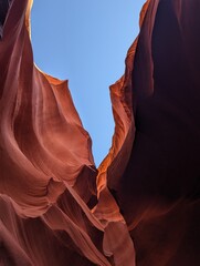 Glowing wavy red rocks with bright blue sky