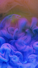 Fototapeta premium Ink drop water. Neon smoke cloud. Defocused blue pink yellow color gradient glowing vapor explosion flow abstract art background.