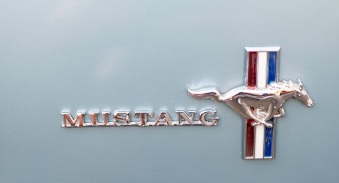 Seattle, WA, USA -July 3, 2024: Mint Red Ford Mustang logo 1965 1966. American classic retro car