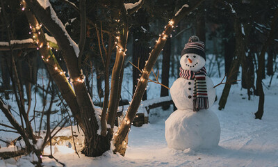A cheerful snowman stands in a snowy park adorned with festive lights