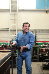 Smiling mechanic loads brake discs for delivery