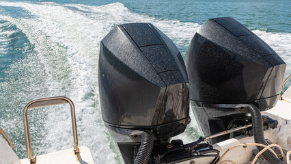 Two high-powered engines mounted on the back of the speedboat