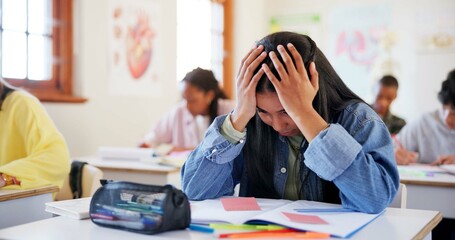 Frustrated girl, student and book with stress for exam, test or evaluation in classroom at school....
