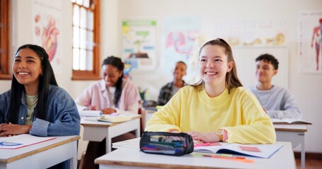 Happy children, students and teenagers with books in classroom for learning or education at school. Young, group or learners in diversity with smile, stationery or desk in class for youth development