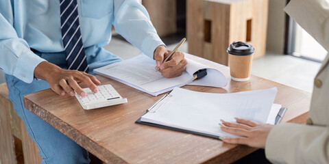 Financial Analyst Conducting Precise Data Entry and Analysis in a Cozy Cafe