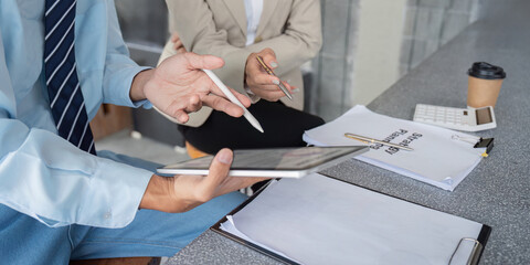 Digital Consultant Discussing Strategic Planning with Client Using Tablet in Cafe