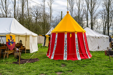 Medieval tent made of red, yellow and white fabric as a dwelling at the medieval market in...