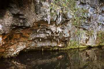 Rocky cave wall with water reflection