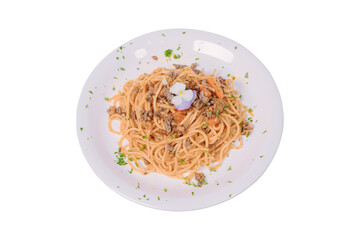 A plate of spaghetti with a classic meat sauce, topped with a small flower and chopped parsley.