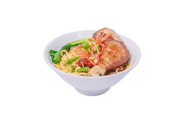 A bowl of noodle soup with a whole chicken leg, vegetables, and a savory broth.