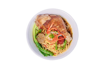 A bowl of noodle soup with a whole chicken leg, vegetables, and a savory broth.