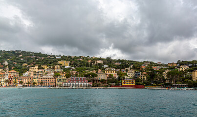 Fototapeta premium Small city near Portofino from the sea with dramatic sky
