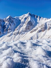 Snow-covered mountain peaks under a bright sky.
