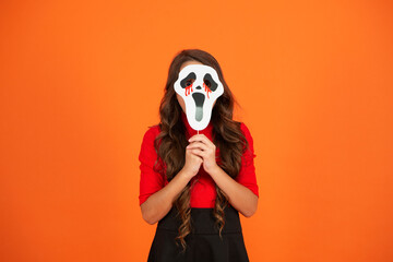 Girl with Halloween ghost mask. Happy Halloween. Girl ghost on Halloween party isolated on orange....