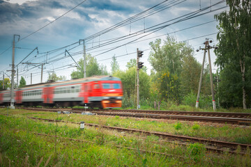 Modern passenger commuter train in motion. Railway station. Railroad with motion blur effect