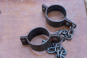 Ancient iron shackles of a slave with a chain