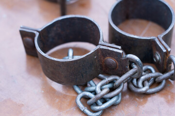 Ancient iron shackles of a slave with a chain