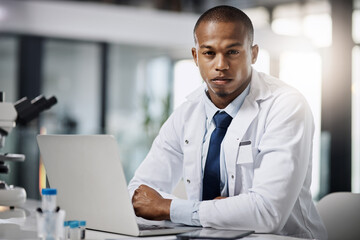 Black man, portrait and laptop in lab for science, innovation and development in medical research. Scientist, confident and computer at desk for forensic analysis, chemistry or engineering in Kenya