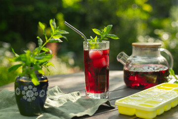 Summer red hibiscus iced tea outdoors. 
