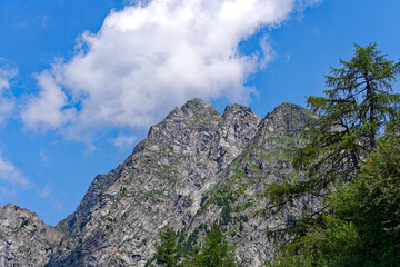 Looking up mountain peaks with rocks and cliffs at mountain resort of Meran Merano 2000 on a summer day. Photo taken July 18th, 2024, Meran Merano, Italy.