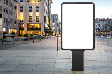 Blank Mockup Of Vertical Street Poster Billboard On City Background. Advertising Empty Outdoor Banner In Front Of Luxury Mall