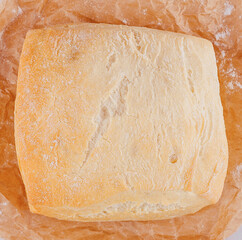 Freshly baked white bread loaf on baking paper